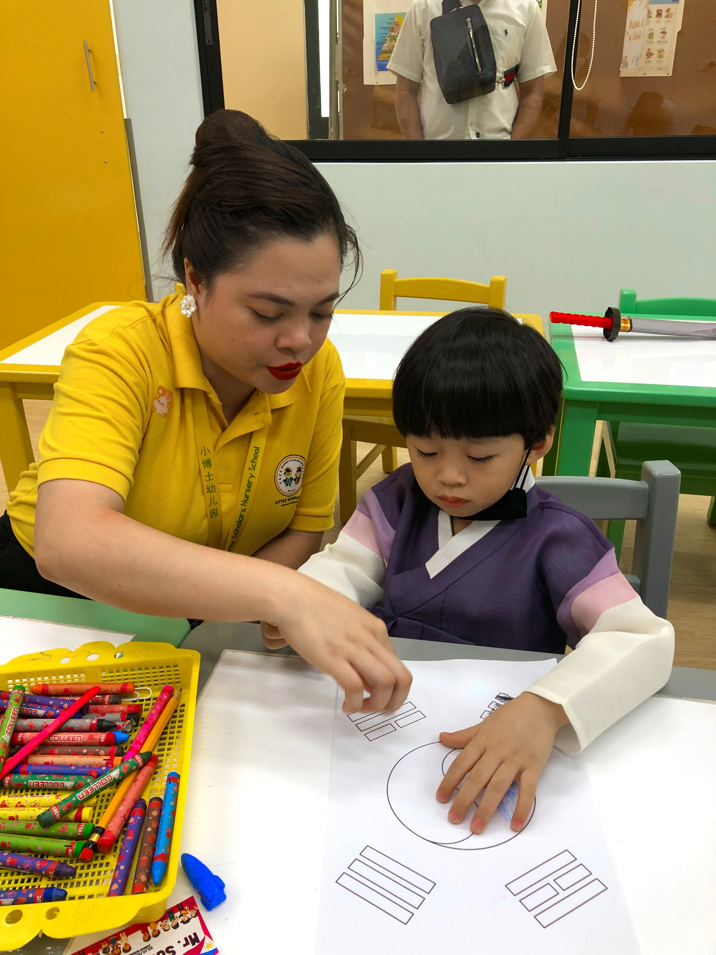 Junior Nursery learner receiving guided classroom support