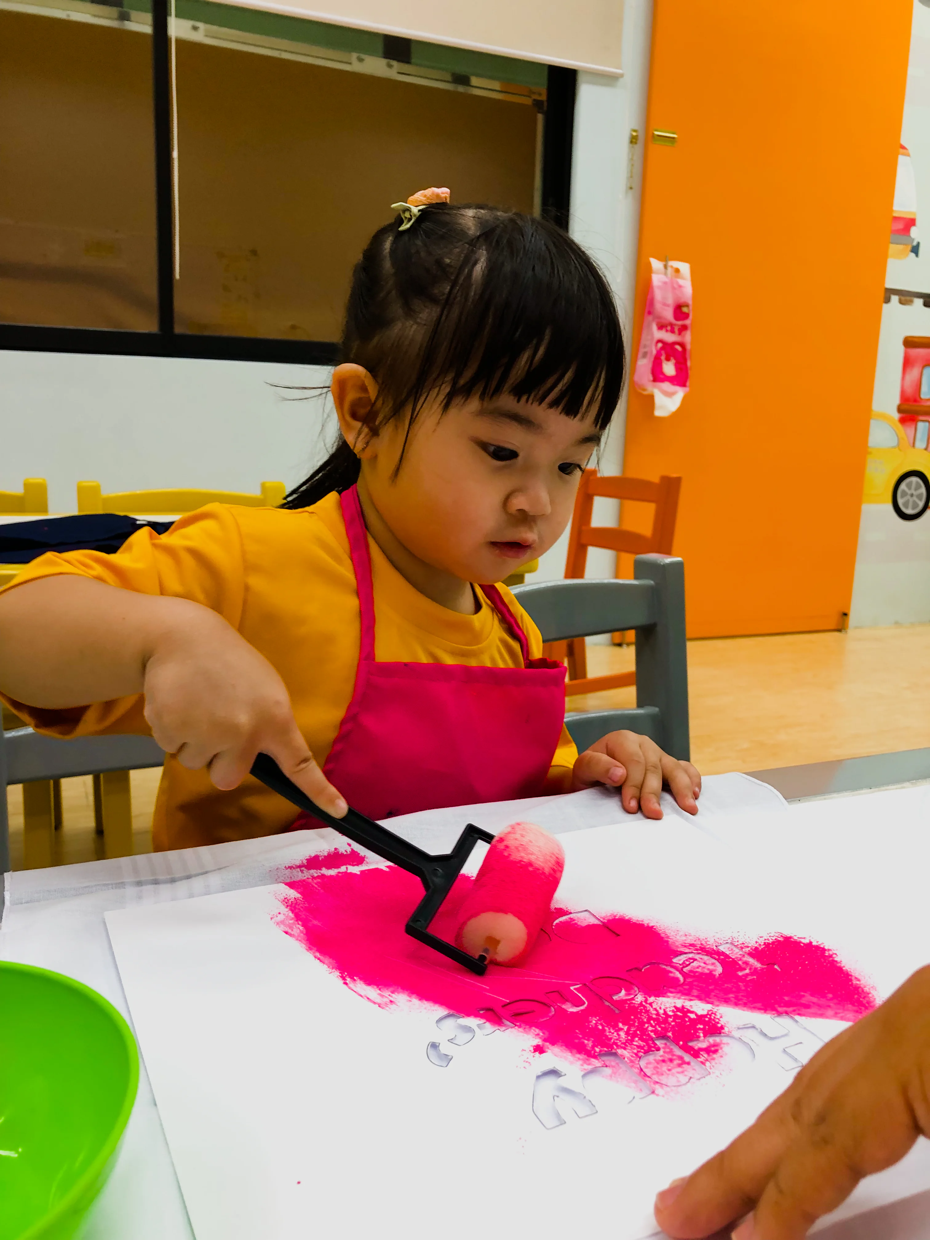 Pre-Nursery learner taking part in a painting activity